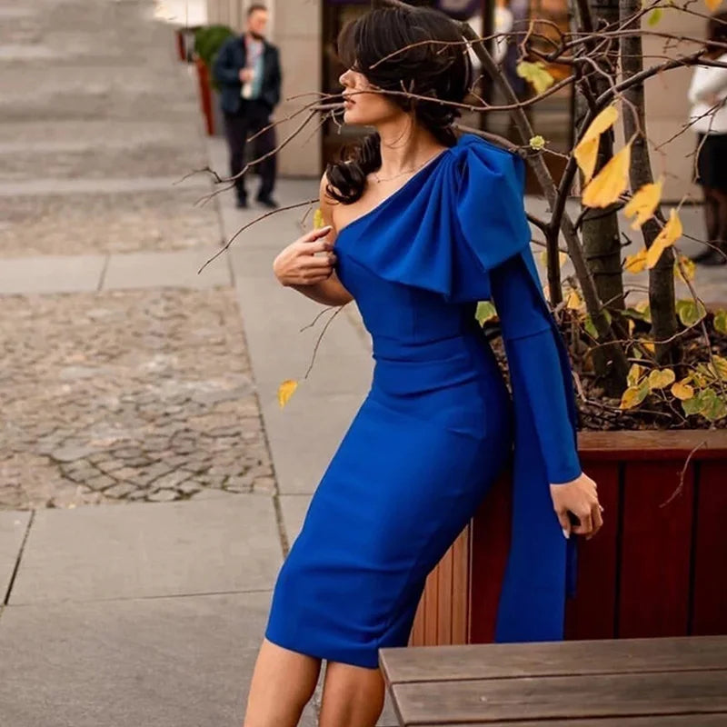 asymmetrical bodycon blue sleeve dress styled for winter cocktails