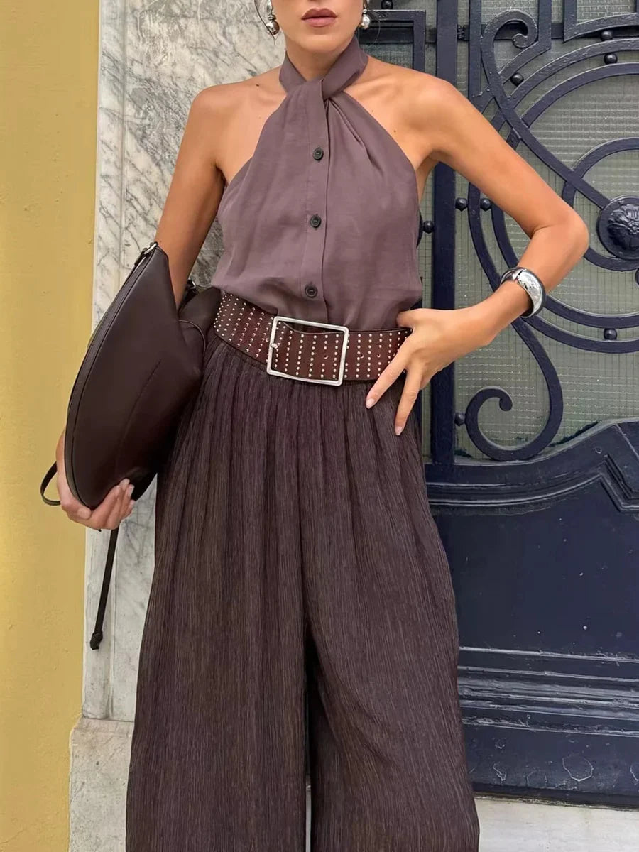 Asymmetrical brown tank paired with wide-leg pants and accessories