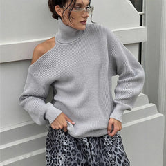 Woman wearing a Autumn INS fashion women’s pullover in trendy gray with cut-out shoulders against a white wall.