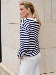 Rear view of blue and white knit cardigan with ponytail hairstyle