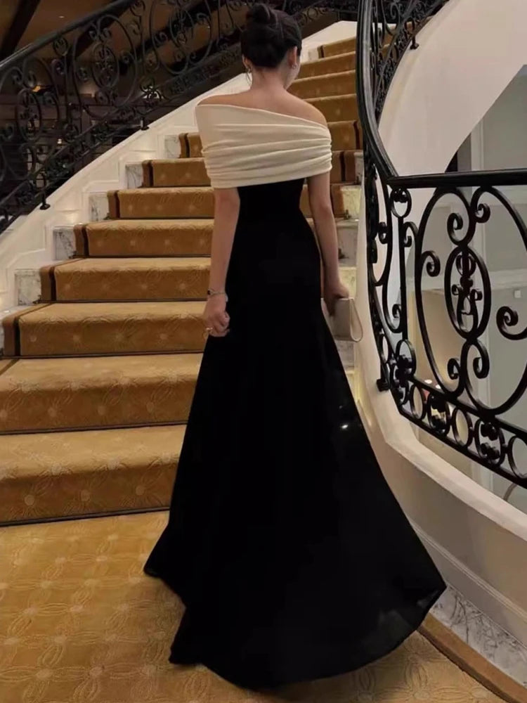 Woman in a black and white dress standing on a staircase
