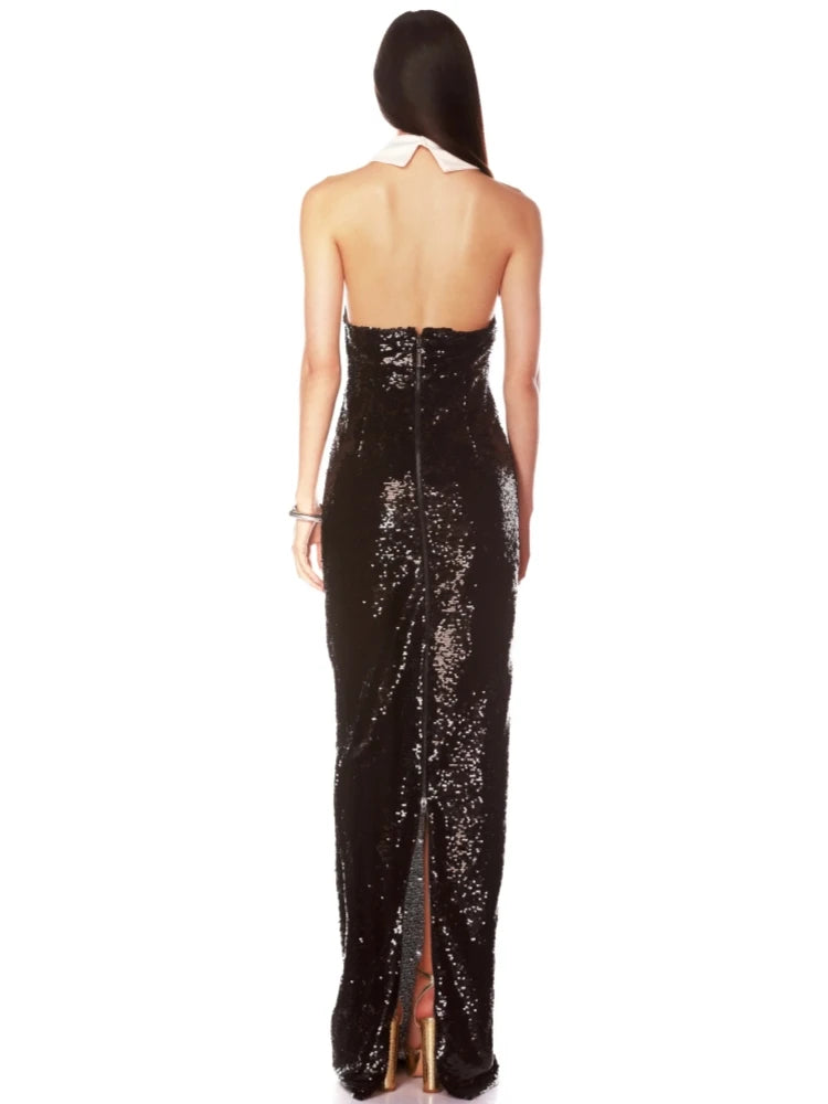 Backless celebrity party gown in black sequins with a white collar, and a high slit on a white background