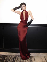 Backless halter gown with lace-up detail and an ankle-length silhouette