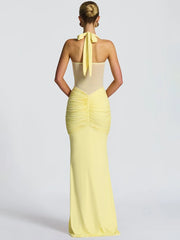 Backless yellow gown with slim silhouette and halter neckline