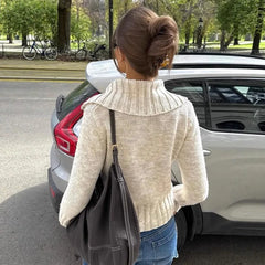 The full length of the knit top, highlighting its flattering silhouette.