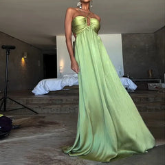 Beach-ready evening dress in green satin with front cutout