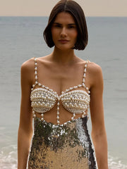 Close-up of the silver dress bodice highlighting beadwork, sequins, and the V-neckline finish.