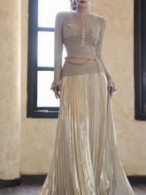 Long sleeve ankle-length dress with pleated skirt and waist belt