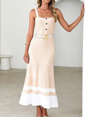 Woman in beige ribbed knit midi dress with white hem and buttons