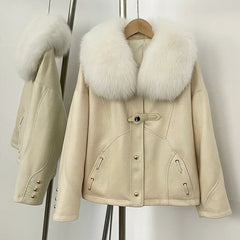 Beige suede down jacket with a white fox fur collar on a hanger.