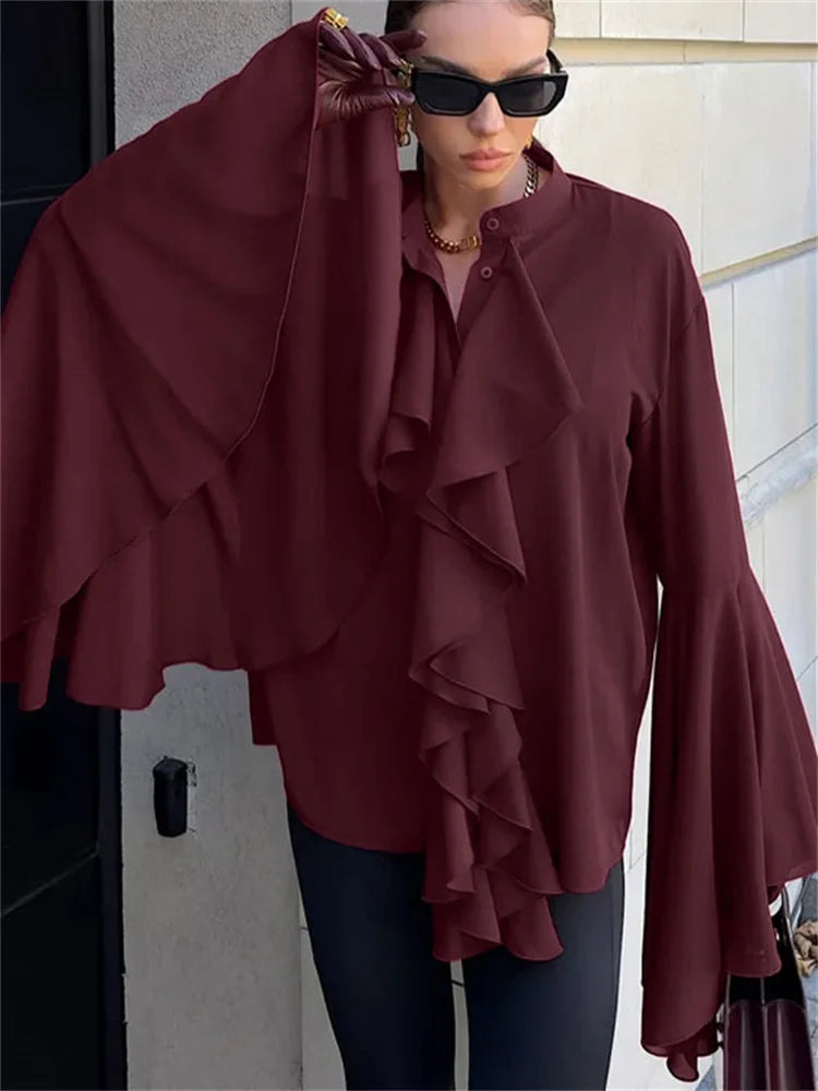 Woman wearing a Close-up of a bell sleeve and ruffle trim on a chiffon blouse