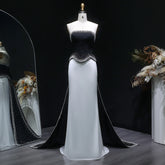 Side view showing sweep train and contrast design on evening dress