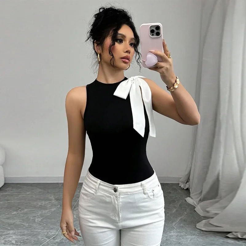Black bow shoulder tank top styled for a crisp monochrome summer look