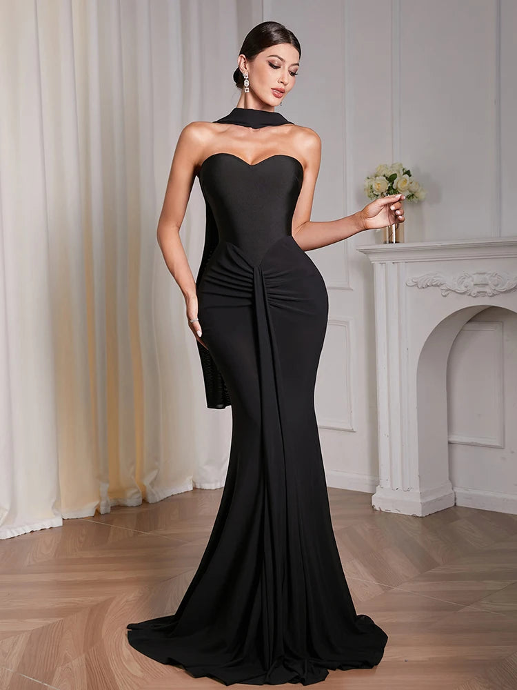 Full-length view of black strapless slim sheath evening gown