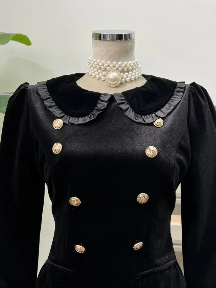 Above-knee black collar dress displayed on mannequin in a studio setting