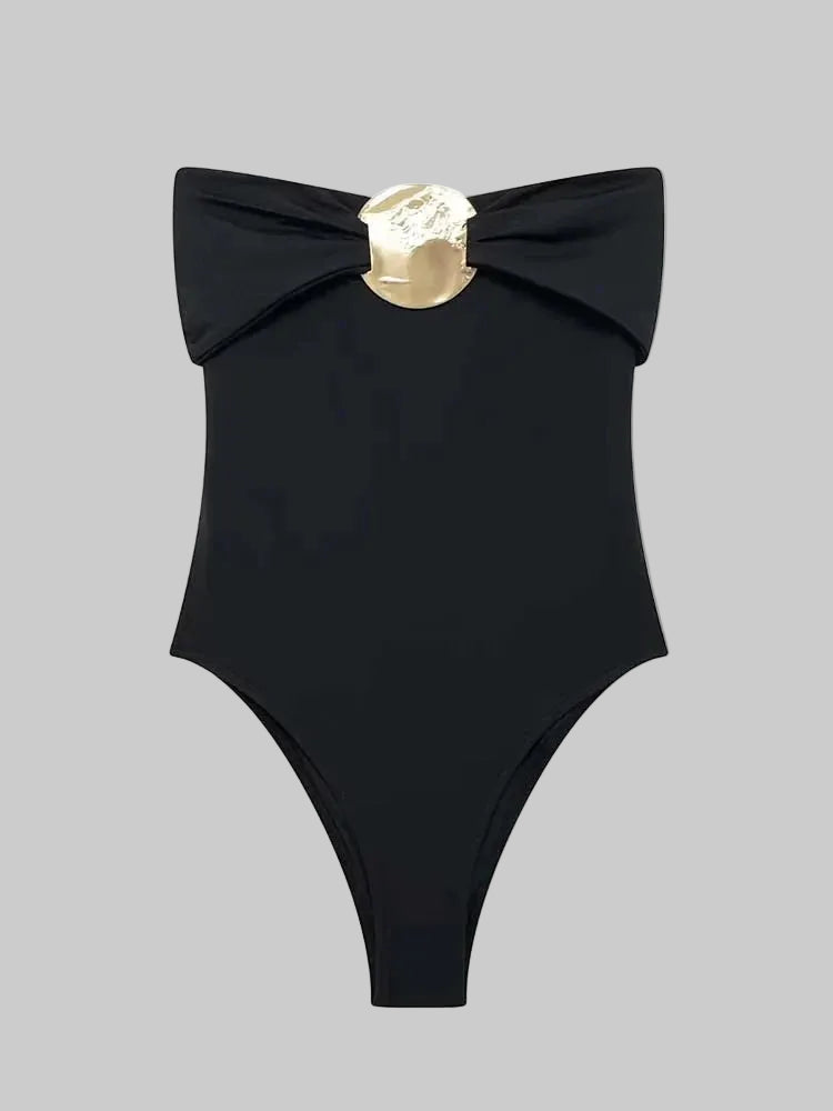 Close-up of the folded off-shoulder neckline and metal hardware, showing the smooth fabric finish and structured drape across the top edge.