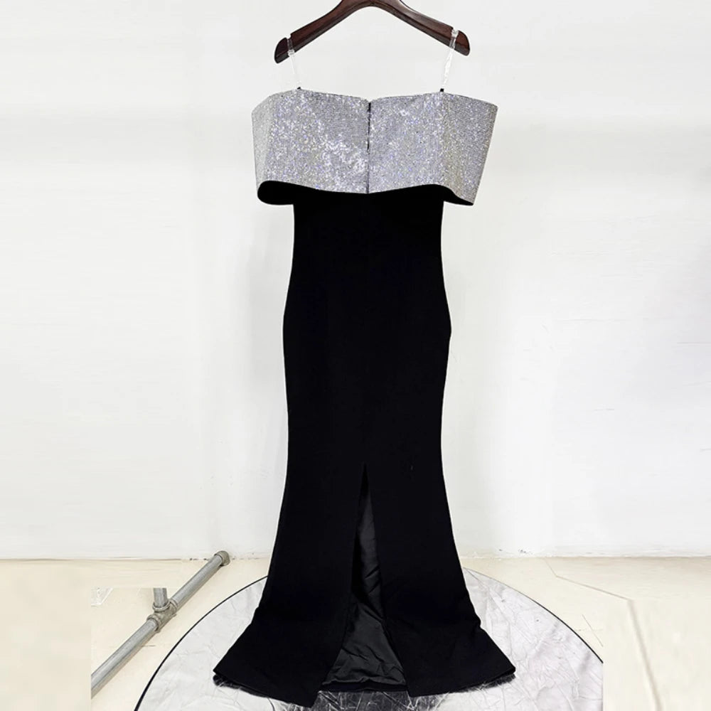 Black maxi dress styled for evening wear, showcasing clean lines and an elegant off-shoulder profile.