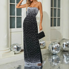 Close-up of pearl-style bead detailing on the bodice of a black strapless evening dress.