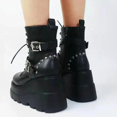 Close-up of punk metal detailing on chunky black boots