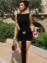 Woman wearing black open back drape waist mini dress outdoors