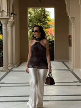 Polka dot halter top with a cropped silhouette and lace detailing