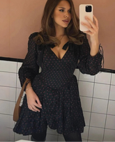 Black polka dot tie mini dress with long sleeves styled for casual city selfies