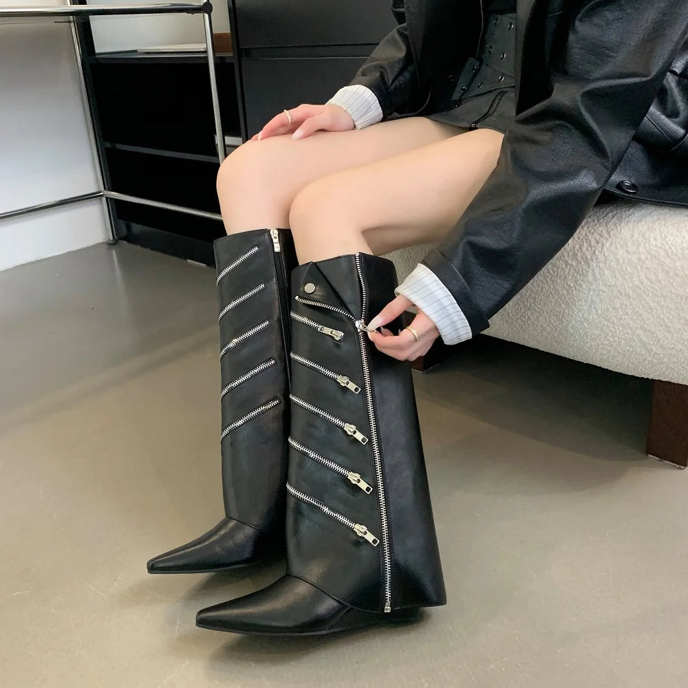 A woman wearing black punk wedge boots styled with a rock-and-roll outfit.