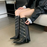 A woman wearing black punk wedge boots styled with a rock-and-roll outfit.