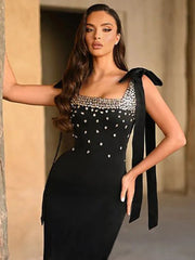Black rhinestone bow mini dress styled for evening parties