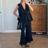 Black ruffle peplum two piece set styled for mirror selfie indoors
