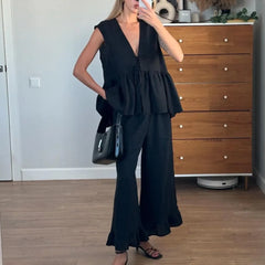 Black ruffle peplum two piece set styled for mirror selfie indoors