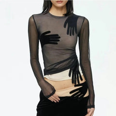 Sheer black top with black gloves and a white skirt on a white background