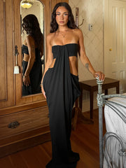 Model wearing a black strapless gown with side cutouts and ruching