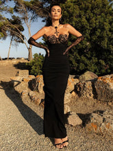 Black strapless lace patchwork dress styled with gloves for evening wear