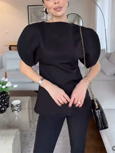 Black knit top with sculpted short puff sleeves and round neckline