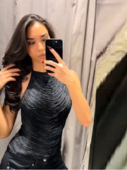 Mirror selfie wearing a black textured halter tank top with a sleek, fitted shape, styled indoors for a night-out look.