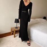 Black V-neck knit maxi dress styled for cozy autumn nights