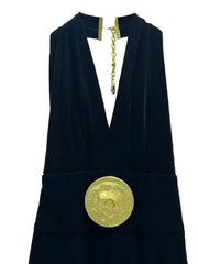 Minimal black wide-leg jumpsuit with statement gold accessories