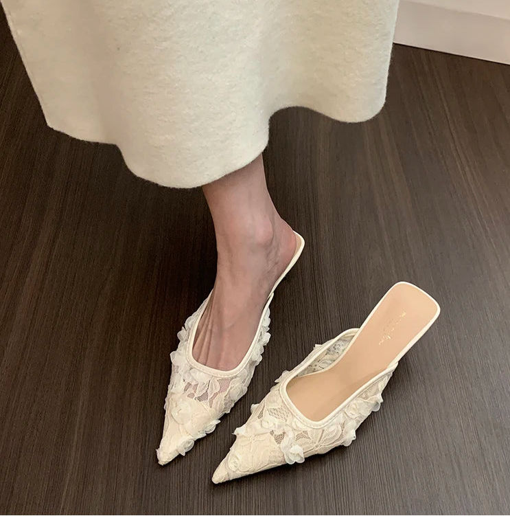 Pair of women’s pointed toe white lace mules for evening wear