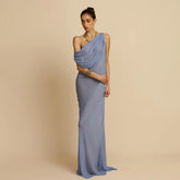 Woman wearing a blue mesh one-shoulder maxi dress styled for an elegant banquet event against a beige background