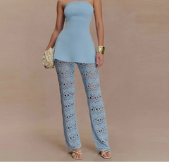 Woman wearing a blue strapless lace pants set styled with gold accessories