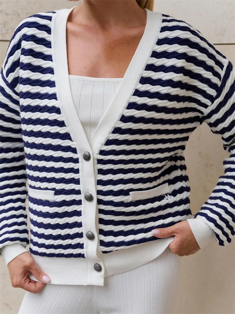Close-up of open front striped cardigan styled with tote bag
