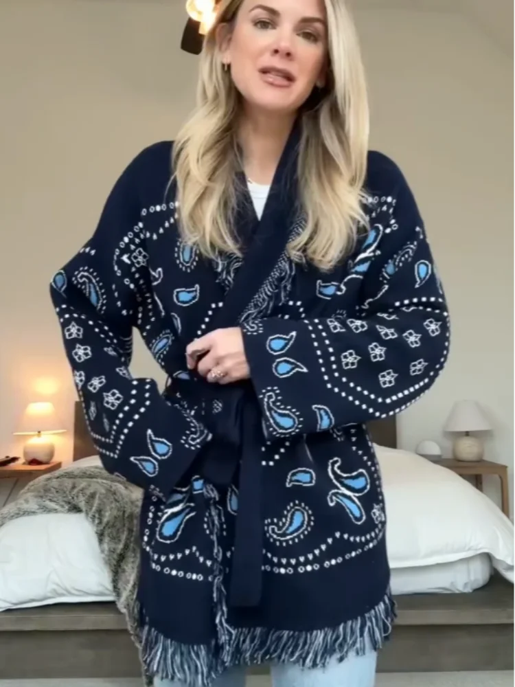 Woman wearing a navy blue patterned robe in a bedroom setting
