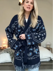 Woman wearing a navy blue patterned robe in a bedroom setting