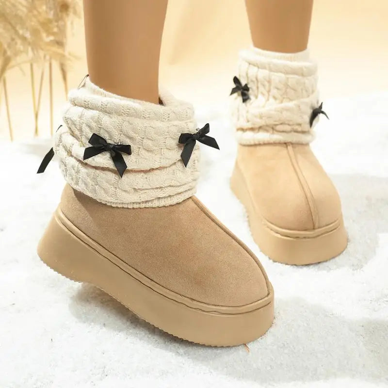 Front view of bowknot faux fur snow boots with knitted leg covers
