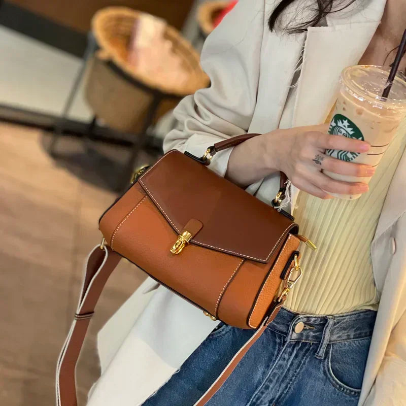 Brown genuine leather messenger bag with shell silhouette and gold-tone clasp detail