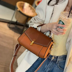 Brown genuine leather messenger bag with shell silhouette and gold-tone clasp detail