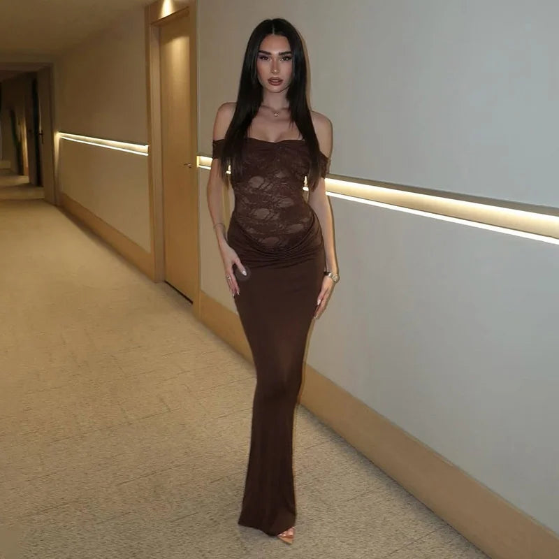 Woman wearing a brown lace patchwork off-shoulder maxi dress in a hallway