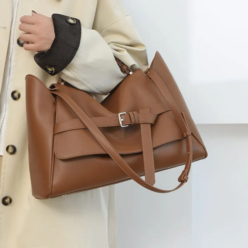 Brown leather shoulder tote styled for modern work and travel needs