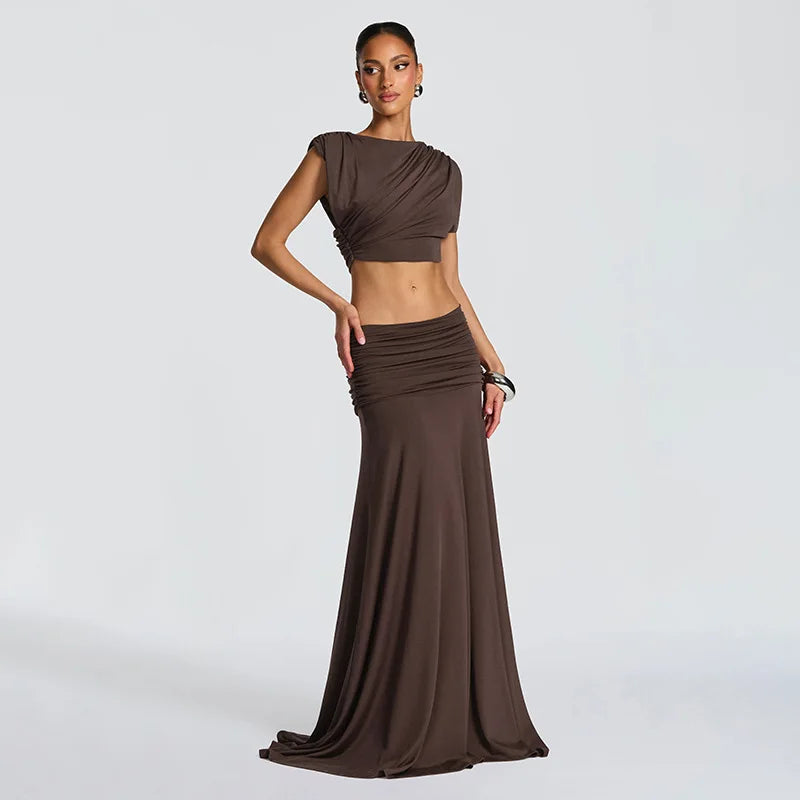 Brown pleated two-piece set with sleeveless crop top and maxi skirt